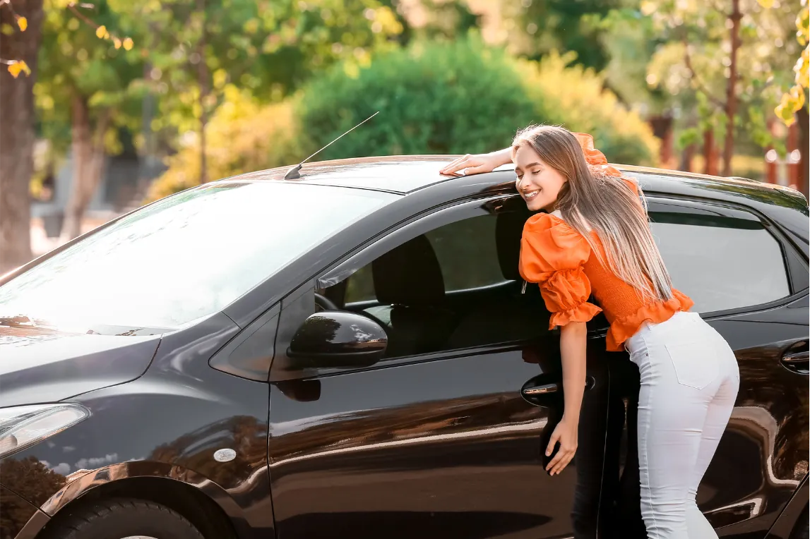happy woman hugging her car
